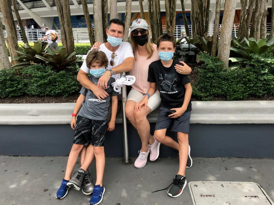 West Palm Beach resdients Scott and Raquel Baugh and their sons Scotty, 10, and Thomas, 7, take a break from the heat at Magic Kingdom Thursday during an annual passholder preview. The park officially reopens Saturday, along with Animal Kingdom, followed by Hollywood Studios and Epcot on July 15.