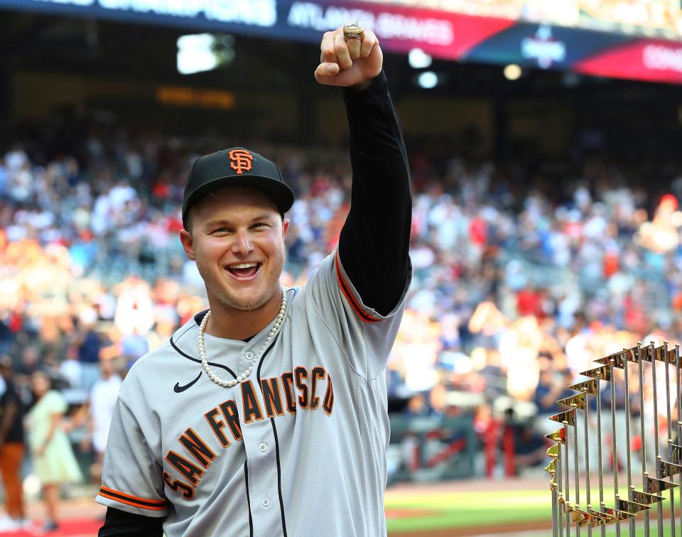 Former Atlanta Braves outfielder Joc Pederson is presented his World Series ring and shows it off proudly to Braves fans before the San Francisco Giants play the Braves in a baseball game on Monday, June 20, 2022, in Atlanta. (Curtis Compton/Atlanta Journal-Constitution via AP)