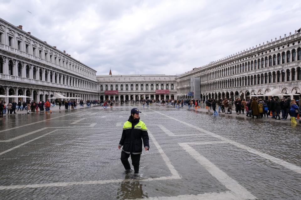 Police officer patrols a flooded St. Mark's Square during seasonally high water in Venice, Italy, November 7, 2021.