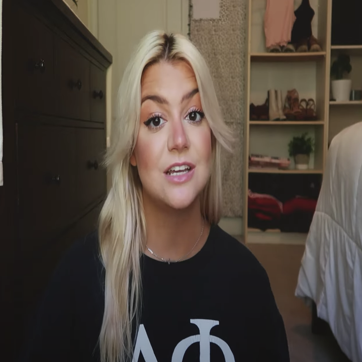 A young woman wearing a Greek shirt