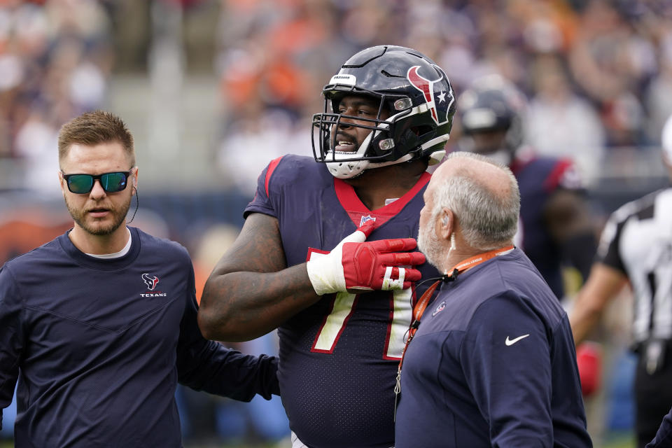 Houston Texans offensive tackle Tytus Howard is helped off the field during the first half of an NFL football game against the Chicago Bears Sunday, Sept. 25, 2022, in Chicago. (AP Photo/Charles Rex Arbogast)