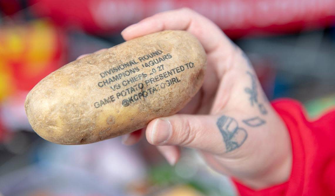 Nicki Conrad, aka “KC Chiefs Potato Girl,” shows a souvenir potato she received in the mail at a tailgating event outside Arrowhead Stadium before the Kansas City Chiefs and Cincinnati Bengals AFC Championship football game on Sunday, Jan. 29, 2023, in Kansas City.