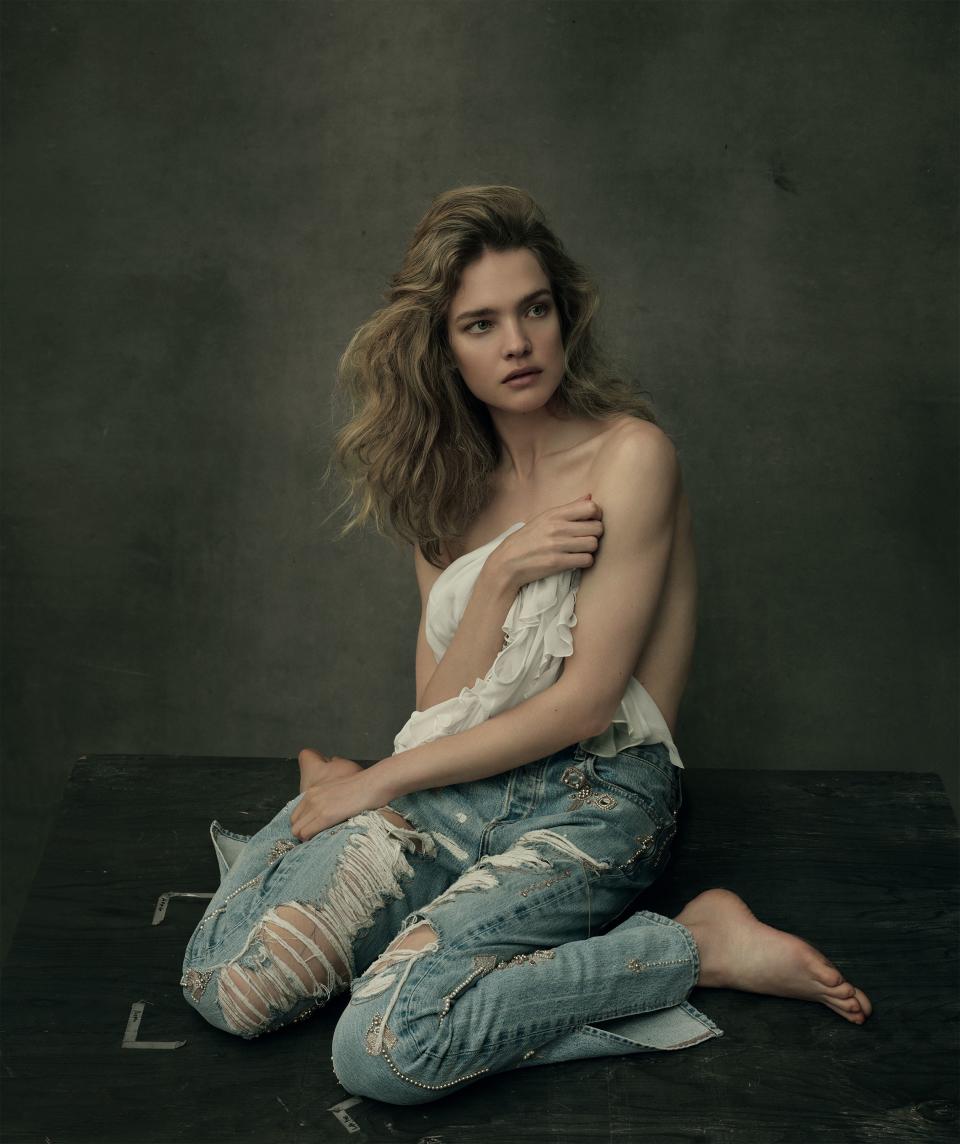 <em>“We were on the roof of the Paris Opéra House and I played this sort of ballerina. You have to forget that the wind is blowing and you’re five stories high. But I love it—I love the thrill.” —Natalia Vodianova.</em> Vodianova wears Jonathan Simkhai jeans ($1,295) and blouse ($595). Blouse at Bergdorf Goodman, NYC. Jeans at jonathansimkhai.com. <em>In this story: Hair: Garren and Thom Priano of Garren New York for R+Co; Makeup: Diane Kendal for Marc Jacobs Beauty; Manicure, Yuko Tsuchihashi. Set Design: Mary Howard. Photographed at The 1896, Brooklyn.</em>