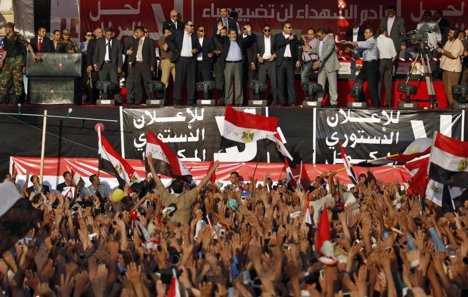 FILE - In this Friday, June 29, 2012 file photo, Egypt's President-elect Mohammed Morsi waves to supporters before giving a speech at Tahrir Square in Cairo, Egypt. Egyptian officials say security authorities leaked a recording of a private conversation between ousted President Mohammed Morsi and his lawyer on the sidelines of his trial, in which Morsi says protests by his supporters and the crackdown on them are "useless." (AP Photo/Khalil Hamra, File)