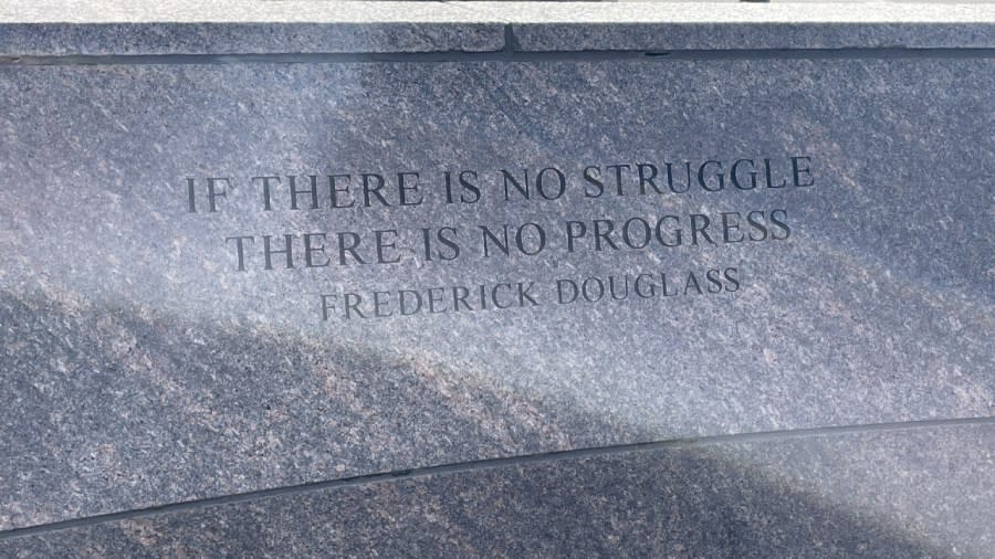 A quote attributed to Frederick Douglass is etched near the "Spirit of Solidarity." It reads: "If there is no struggle, there is no progress."