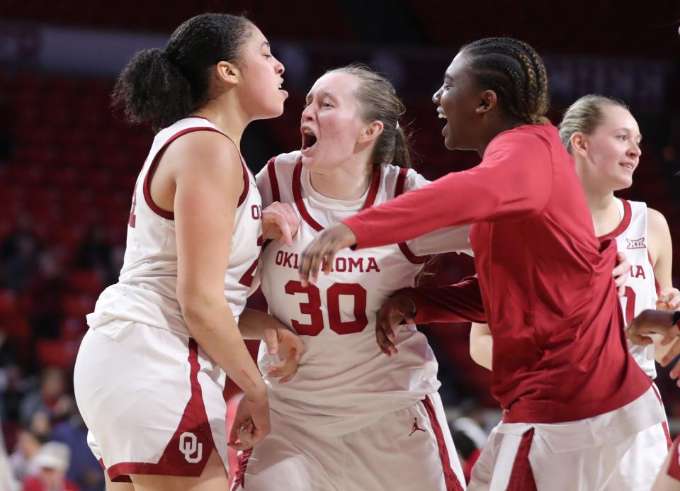 OU's Skylar Vann (24) celebrates with Taylor Robertson (30) after Vann made a basket to send the game to overtime Wednesday at Lloyd Noble Center in Norman. The Sooners beat Kansas State 90-86 in overtime.