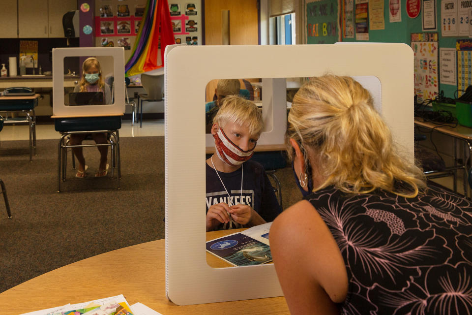 Teacher Lorrie Tine and fourth-grader Egan Anderson work on a reading lesson | Gillian Laub for TIME