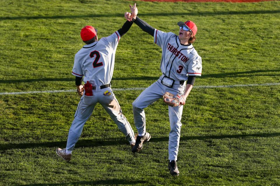Thurston’s Easton McDonald, left, and Kyle Miller celebrate as the Thurston Colts defeated the North Eugene Highlanders 9-0 Wednesday, April 12, 2023 at North Eugene High School.