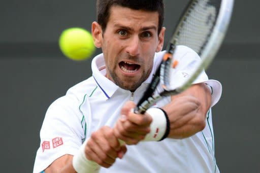 Serbia's Novak Djokovic plays a double-handed backhand shot during his men's singles quarter-final match against Germany's Florian Mayer on day nine of the 2012 Wimbledon Championships tennis tournament at the All England Tennis Club in Wimbledon, southwest London. Djokovic won the match