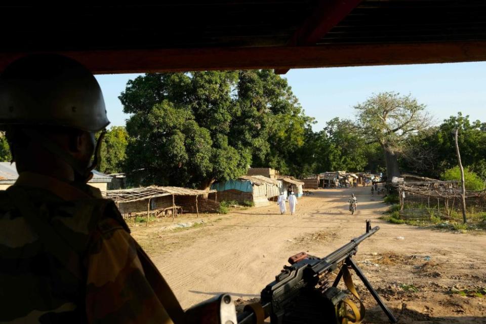 A Central African soldier patrols at the market in Birao, Central African Republic in November 2019, where thousands of people have died in an armed conflict.