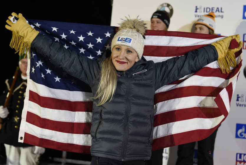 FILE - Gold medalist Kaillie Humphries of the United States celebrates during the medal ceremony for the two-woman bobsled competition at the Bobsleigh and Skeleton World Championships in Altenberg, Germany, in this Saturday, Feb. 22, 2020, file photo. Humphries will seek a record fourth women's bobsled world championship this weekend in Altenberg. (AP Photo/Jens Meyer, File)