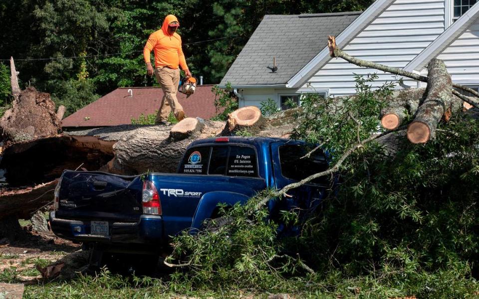 Crews work to remove a downed tree near Guess Road Wednesday, August 16, 2023, following Tuesday evening’s strong storms in Durham, N.C. Kaitlin McKeown/kmckeown@newsobserver.com