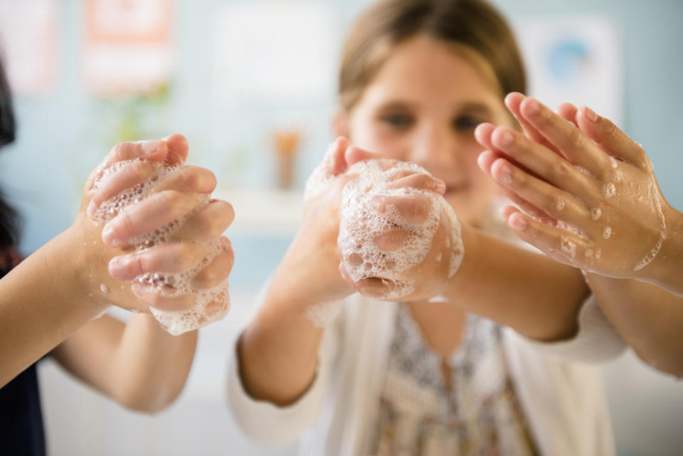 Girls washing hands with soap