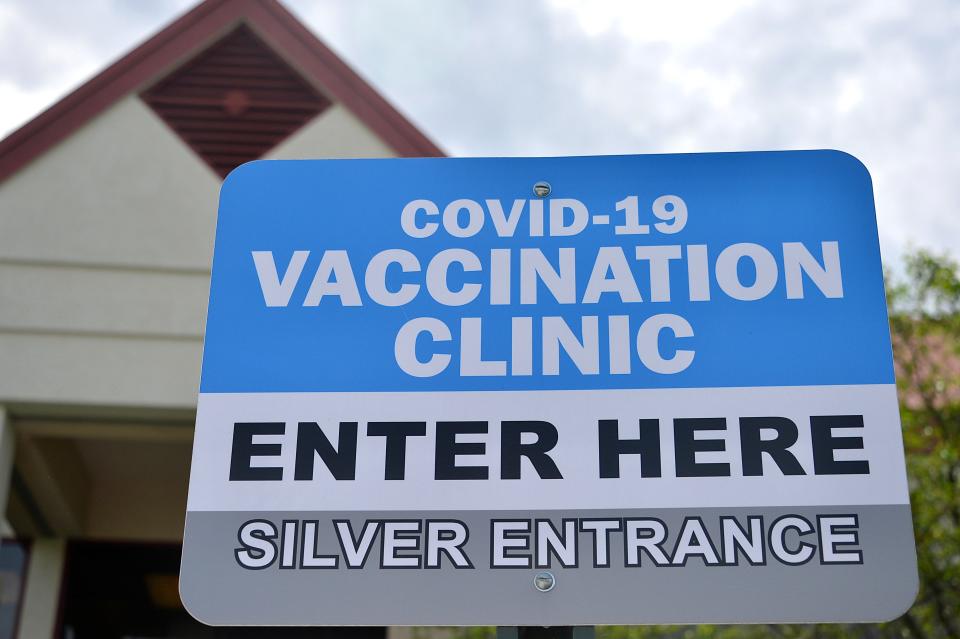 A sign marks the entrance for the COVID-19 vaccination clinic at Robinwood Professional Center.