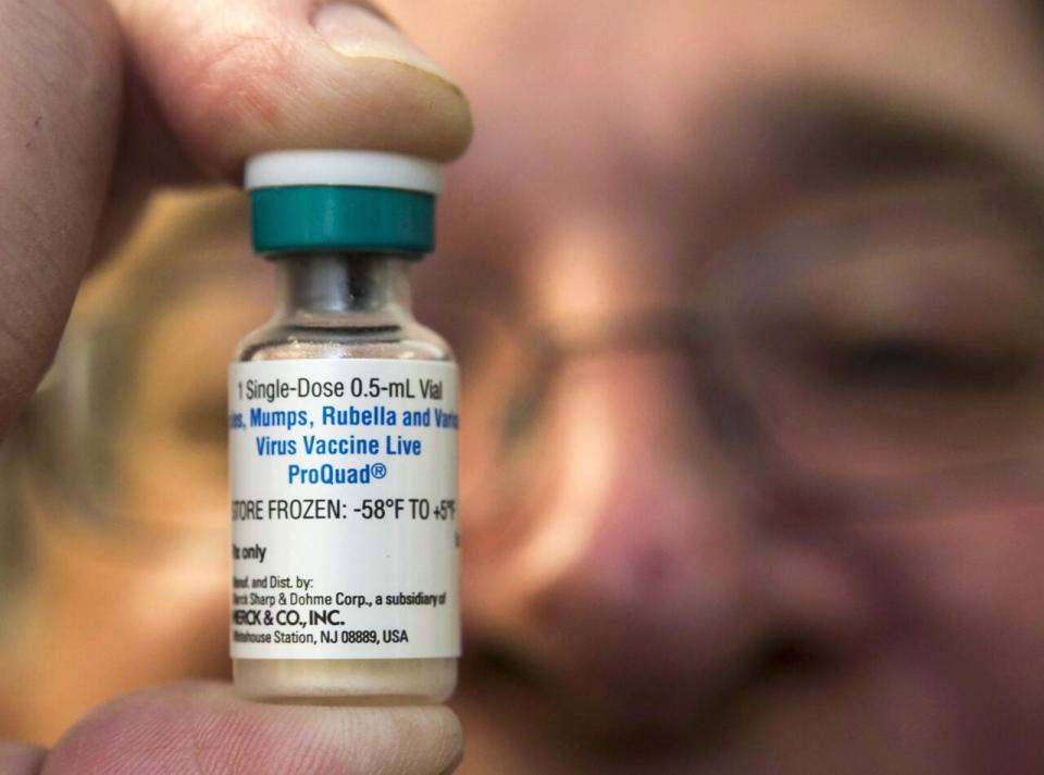 A pediatrician in Northridge, Calif., holds a dose of the measles-mumps-rubella (MMR) vaccine on Jan. 29, 2015.