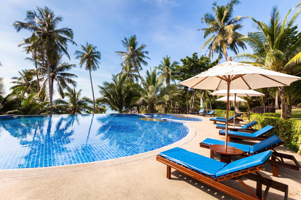 Pictured is a pool and palm trees at the Thailand resort.