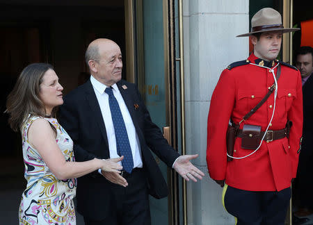 Canada's Minister of Foreign Affairs Chrystia Freeland and France's Minister of Europe and Foreign Affairs Jean-Yves Le Drian gesture prior to a reception at the Royal Ontario Museum on the first day of meetings for foreign ministers from G7 countries in Toronto, Ontario, Canada April 22, 2018. REUTERS/Fred Thornhill