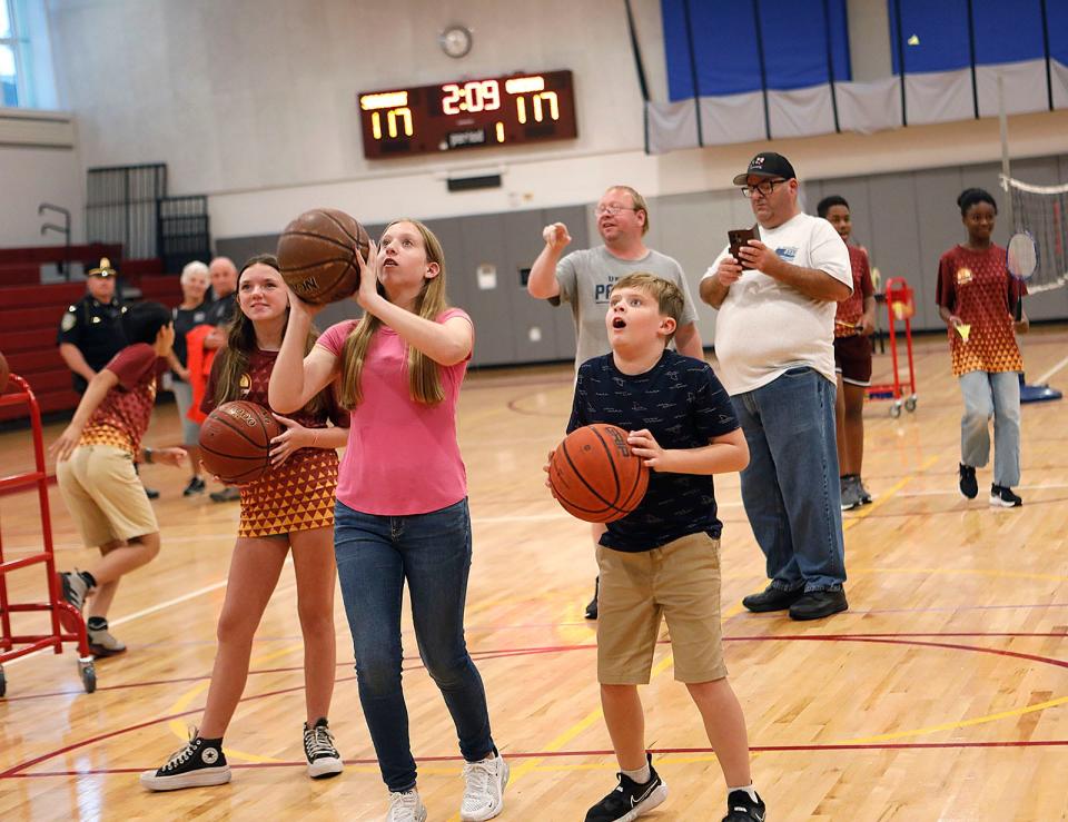 Olivia and Jack Chesna aim for the basket at the Chapman Middle School gym after it was dedicated to their father, the late Weymouth police Sgt. Michael Chesna, on Monday, Sept. 18, 2023.