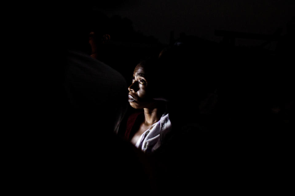 <p>The face of an Internally Displaced Person (IDP) is lighted by a torch light at a camp for IDP’s fleeing from the conflict in the Kasai Province on June 3, 2017 in Kikwit, Democratic Republic of Congo. (Photo: John Wessel/AFP/Getty Images) </p>