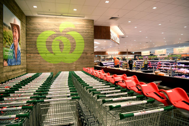 Pictured is a Woolworths store, with lines of trolleys at the front for customers to use.