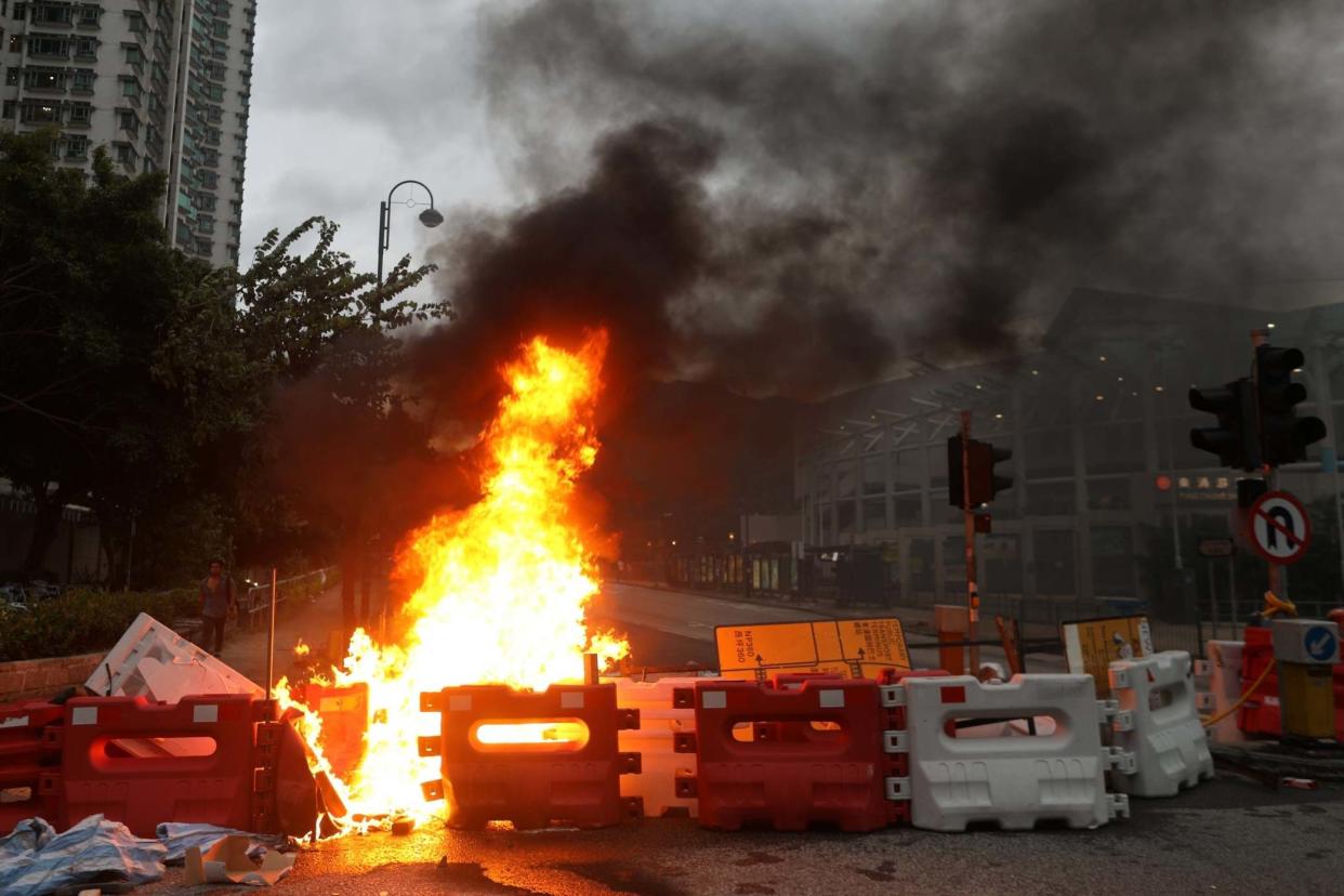 Protesters set barricades on fire near the Tung Chung MTR station in Hong Kong: EPA