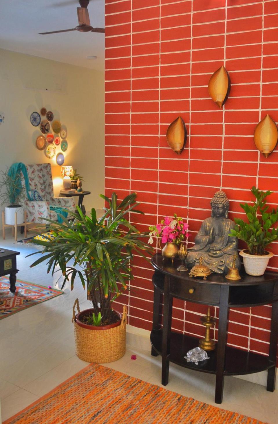 The foyer is blissful with a statue of the Buddha, potted plants, a traditional oil lamp and wall-mounted t-light-holders. “This space gives me lots of positive vibes,” says Preeti.