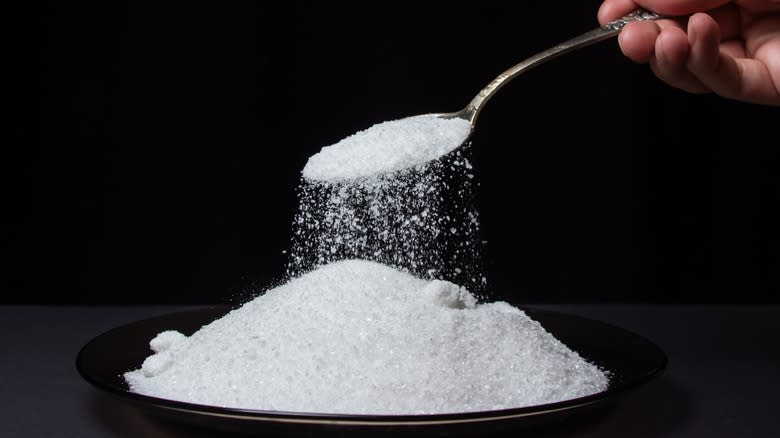 spoonful of sea salt over plate of salt