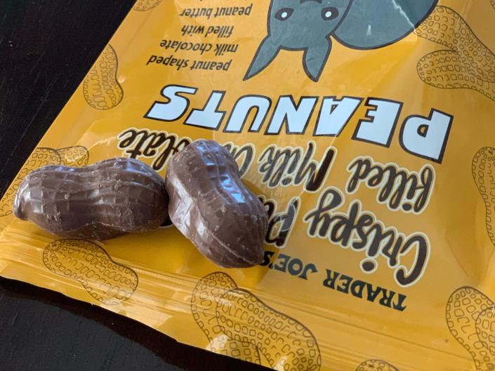 a couple of trader joe&#39;s peanut butter and chocolate peanuts on top of orange bag