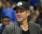 FILE - In this March 3, 2017, file photo, former cyclist Lance Armstrong stands on the court after an NBA basketball game between the Cleveland Cavaliers and Atlanta Hawks in Atlanta. The Associated Press asked eight of the greatest current and former champions, including Armstrong, from seven different sports to find out what impressed them most about Tom Brady. (AP Photo/Brett Davis, File)