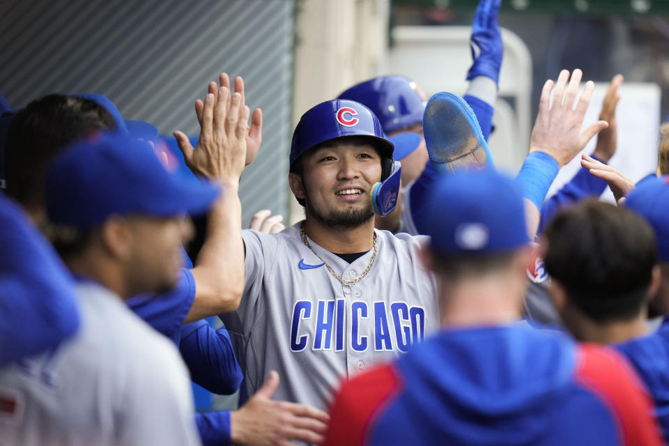 Chicago Cubs' Seiya Suzuki, center, is greeted by teammates after he scored on a single by Mike Tauchman against the Los Angeles Angels during the second inning of a baseball game Tuesday, June 6, 2023, in Anaheim, Calif. (AP Photo/Jae C. Hong)