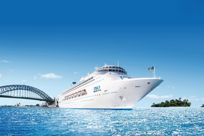 The P&O Pacific Jewel ship cruising on the water with a bridge in the background.