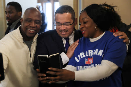 Liberian activists take a selfie with Minnesota Attorney General Keith Ellison at a Deferred Enforced Departure (DED) immigration status rally at the Minnesota State Capitol in St. Paul, Minnesota, U.S. February 22, 2019. Picture taken February 22, 2019. REUTERS/Jonathan Ernst