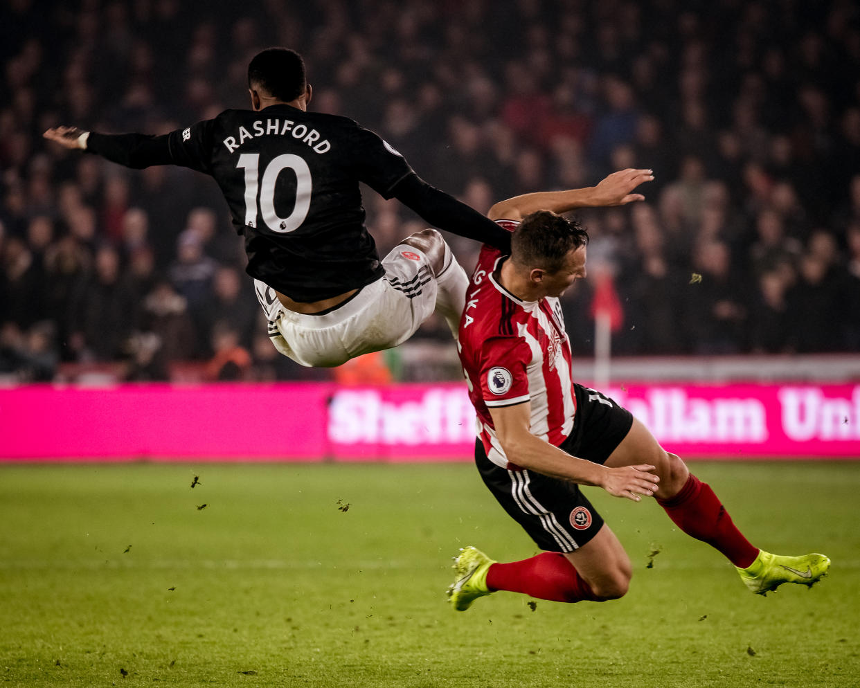 Manchester United's Marcus Rashford (10) collides with Sheffield United's Phil Jagielka on Sunday at Bramall Lane. (Photo by Ash Donelon/Manchester United via Getty Images)