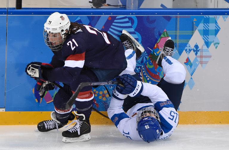 Hilary Knight (left) of the US clashes with Finland's Minnamari Tuominen during a Women's Ice Hockey Group A match at the Shayba Arena during the Sochi Winter Olympics on February 8, 2014