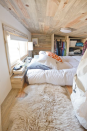 <p>This serene tiny house in rural California is home to web designer Alek Lisefski, his girlfriend, Anjali, and their dog, Anya. Built on an 8- by 20-foot trailer, with three feet added for the back porch, the house features 10 windows and an all-glass door to opening up the <a href="http://tiny-project.com/completed-house-photos/" rel="nofollow noopener" target="_blank" data-ylk="slk:small interior space;elm:context_link;itc:0;sec:content-canvas" class="link ">small interior space</a> to the outdoors to feel less claustrophobic and more connected to the surroundings. Designed and built by Alek himself for about $30,000, he is now <a href="https://tiny-project.com/" rel="nofollow noopener" target="_blank" data-ylk="slk:selling construction plans;elm:context_link;itc:0;sec:content-canvas" class="link ">selling construction plans</a> so others can can build a house of their own to the same specs.</p><p><strong>RELATED: <a href="https://www.countryliving.com/home-maintenance/organization/advice/g104/small-space-decorating-0109/" rel="nofollow noopener" target="_blank" data-ylk="slk:Small-Space Decorating Ideas;elm:context_link;itc:0;sec:content-canvas" class="link ">Small-Space Decorating Ideas</a></strong></p>