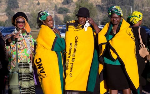 Mourners gather near Soweto's Orlando stadium for the funeral  - Credit: AP