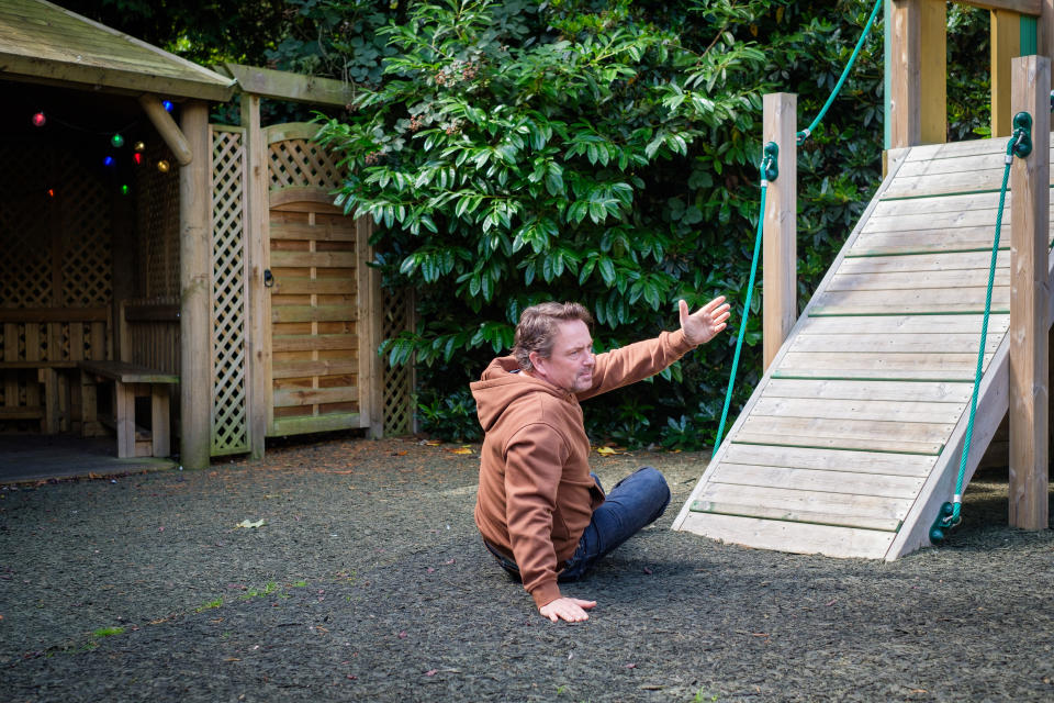 Dave Chen-Williams lying on the ground of the playground.