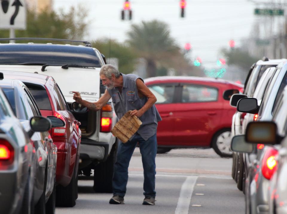 In the past, panhandlers who boldly walk into traffic, like this man at International Speedway Boulevard and Ridgewood Avenue, might find themselves in police handcuffs.
