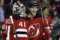 New Jersey Devils goaltender Vitek Vanecek (41) and Damon Severson celebrate after defeating the Edmonton Oilers in an NHL hockey game Monday, Nov. 21, 2022, in Newark, N.J. (AP Photo/Adam Hunger)