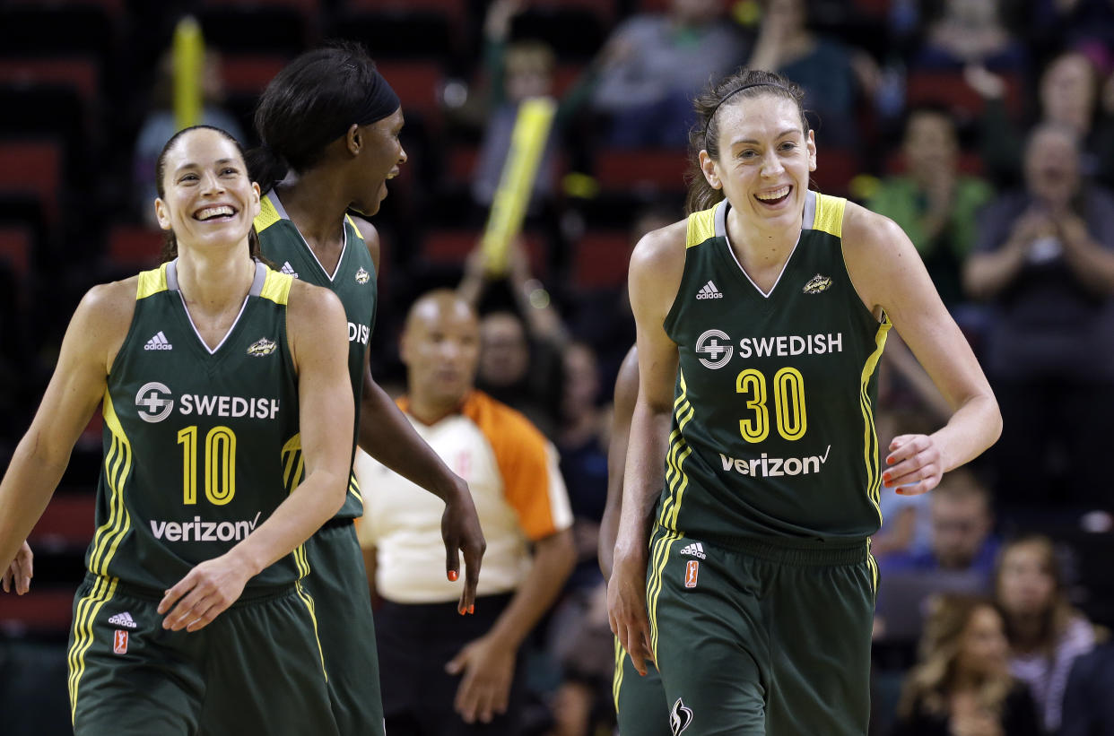Seattle Storms' Sue Bird (10) and Breanna Stewart (30) smile as they leave the court for a timeout against the Connecticut Sun in a WNBA basketball game Saturday, May 28, 2016, in Seattle. (AP Photo/Elaine Thompson)