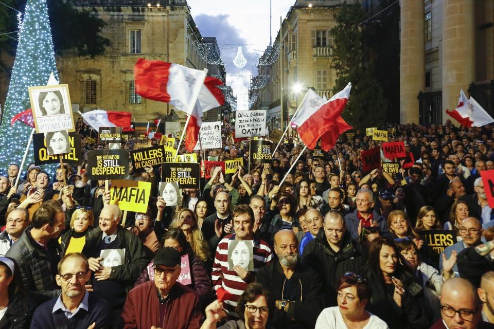 People stage a protest in La Valletta, Malta, Sunday, Dec. 1, 2019. Malta's embattled prime minister has received a pledge of confidence from Labor Party lawmakers amid demands for his resignation by citizens angry over alleged links of his former top aide to the car bomb killing of a Maltese anti-corruption journalist. Hours later, thousands of Maltese protested outside a courthouse demanding that Joseph Muscat step down. (AP Photo)