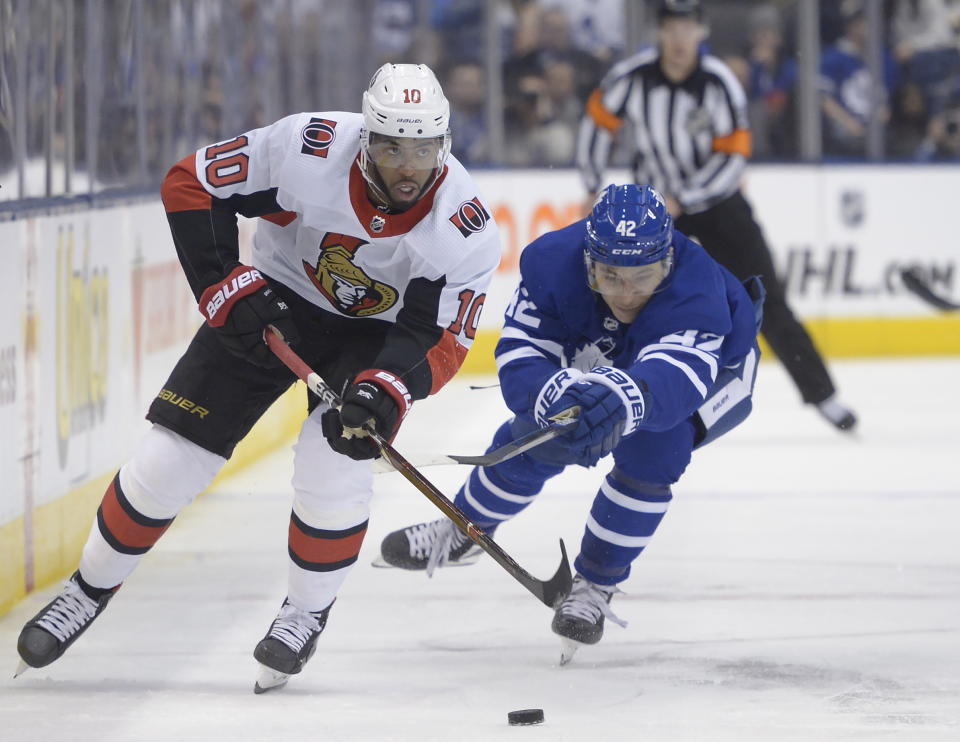 Ottawa Senators left wing Anthony Duclair (10) carries the puck as Toronto Maple Leafs left wing Trevor Moore (42) defends during third period NHL hockey action in Toronto, Saturday, Feb. 1, 2020. (Nathan Denette/The Canadian Press via AP)