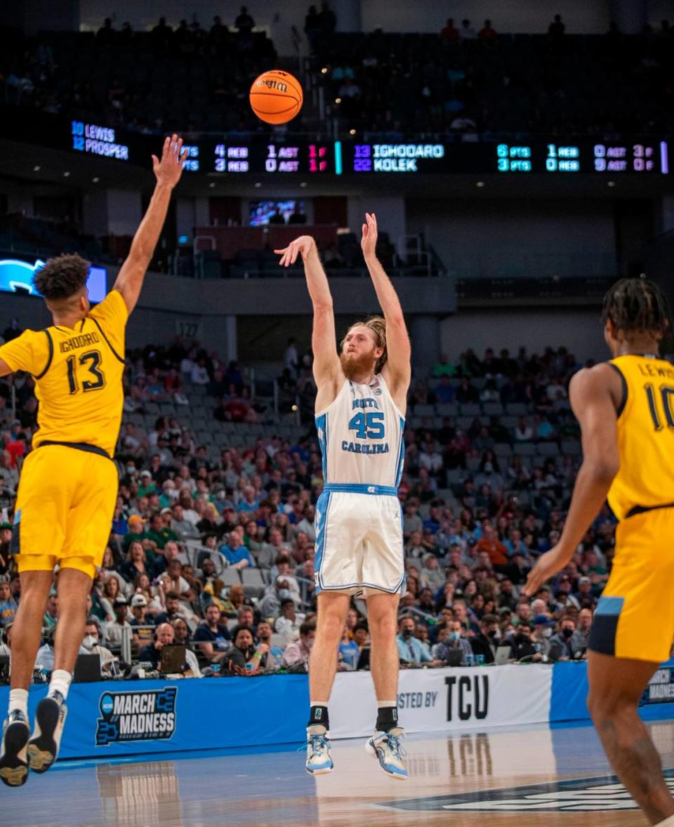 North Carolina’s Brady Manek (45) launches a three-point shot in the second half against Marquette’s Olivier-Maxence Propser (12) on Thursday, March 17, 2022 during the NCAA Tournament at Dickies Arena in Ft. Worth, TX.