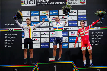 Gold medalist Benoit Cosnefroy of France, flanked by silver medalist Lennard Kamna (L) of Germany and Michael Carbel Svendgaard (R) of Denmark on the podium after UCI Cycling Road World Championships Men Under 23 in Bergen, Norway September 22, 2017. NTB Scanpix/Cornelius Poppe via REUTERS