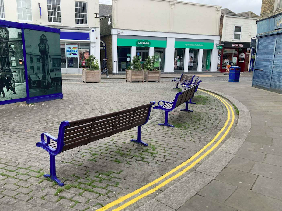The double yellow lines are painted behind a bench in a car-free pedestrian zone. (SWNS)