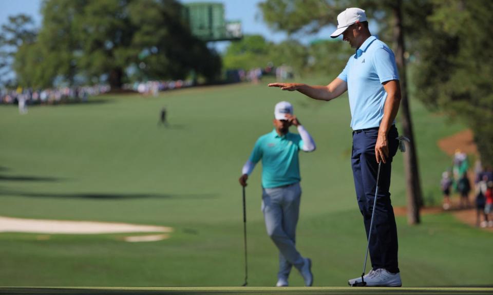 <span>Ludvig Åberg lines up his putt on the green on the 10th hole at the Masters as Matthieu Pavon looks on.</span><span>Photograph: Brian Snyder/Reuters</span>