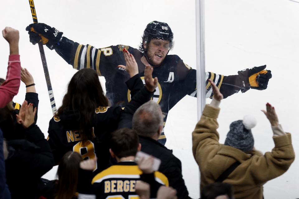 Boston Bruins' David Pastrnak celebrates after scoring against the New Jersey Devils for the second time in the second period of an NHL hockey game Saturday, Dec. 30, 2023, in Boston. (AP Photo/Michael Dwyer)