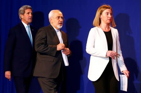 EU foreign policy chief Federica Mogherini and Iran's Foreign Minister Javad Zarif arrive for a joint statement followed by U.S. Secretary of State John Kerry (R-L) in Lausanne April 2, 2015. REUTERS/Ruben Sprich