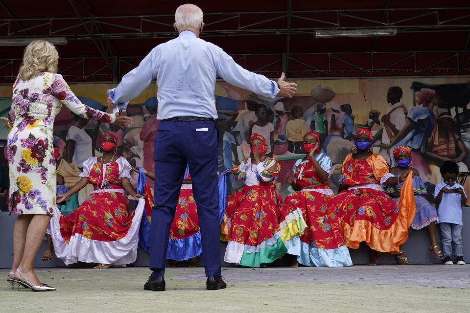 Democratic presidential candidate former Vice President Joe Biden and his wife Jill Biden talk with dancers who performed as they visit Little Haiti Cultural Complex, Monday, Oct. 5, 2020, in Miami. (AP Photo/Andrew Harnik)