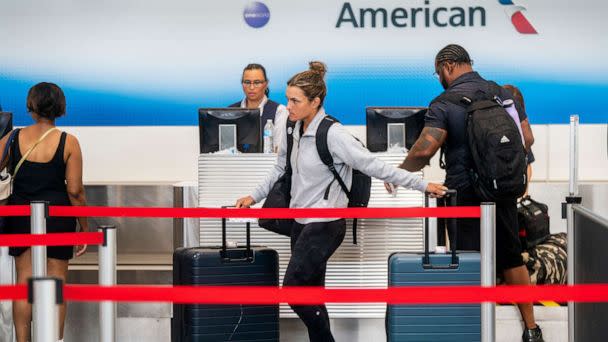 PHOTO: In this July 1, 2022, file photo, passengers check in at the American Airlines ticketing counter at Ronald Reagan Washington National Airport in Arlington, Va. (Shawn Thew/EPA via Shutterstock, FILE)